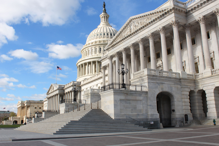 United States Capitol Building In Washington, DC, Situated Against A Clear Blue Sky